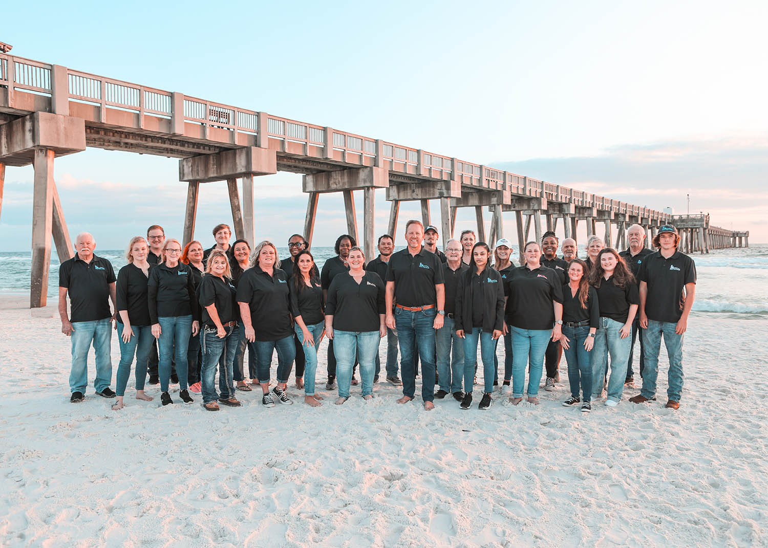Book That Condo Employees in front of a Pier extending to the Gulf